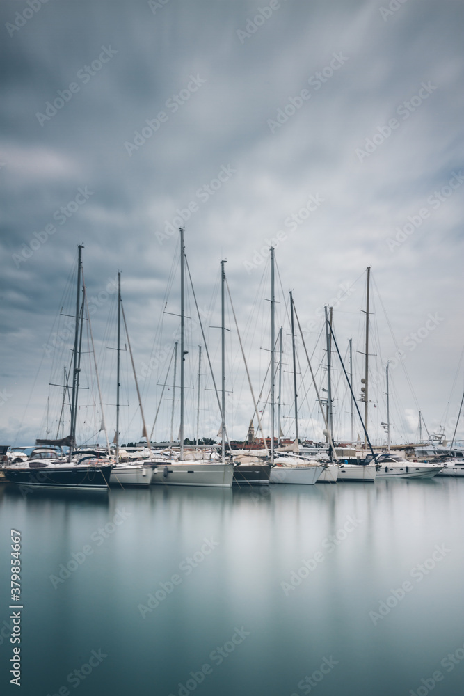Pier with many yachts in moody weather. Pier with many yachts in moody weather.