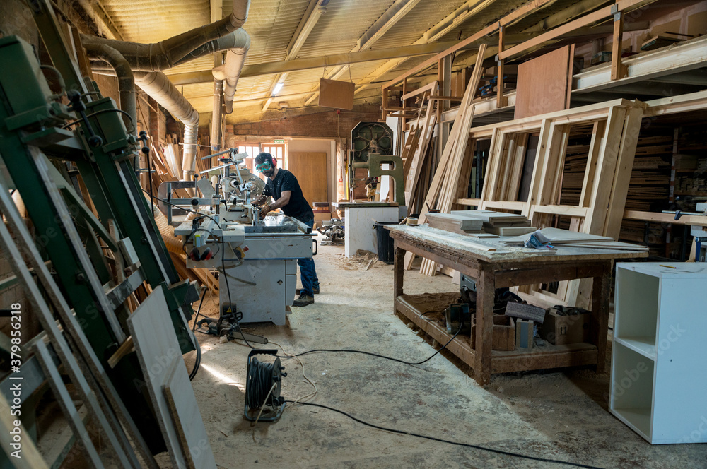 Carpenter polishing a piece of wood Carpenter polishing a piece of wood