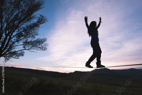 Wallpaper Mural Man's silhouette stepping on slackline outdoor in the twilight Torontodigital.ca