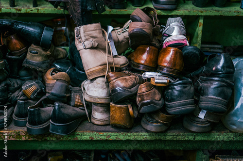 A bunch of old shoes sitting on a shelf