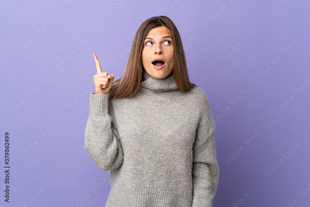 Young Slovak woman isolated on purple background intending to realizes the solution while lifting a finger up Young Slovak woman isolated on purple background intending to realizes the solution while lifting a finger up
