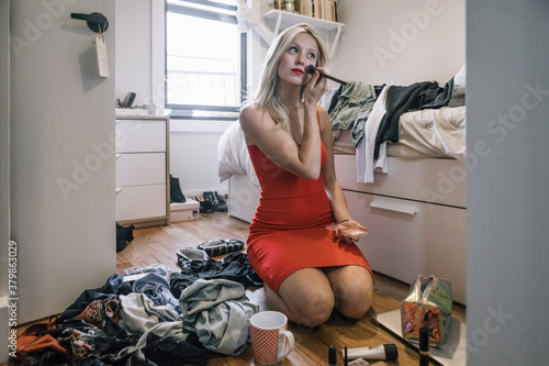 Girl Gets Dolled Up and Puts On Make up in Her Small Bedroom photo