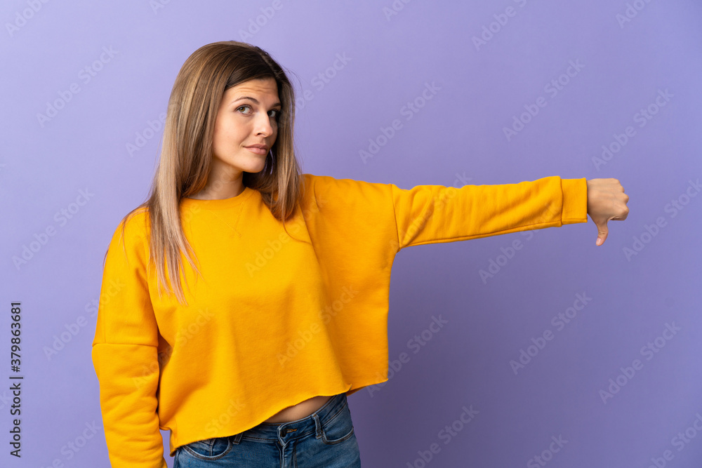 Young Slovak woman isolated on purple background showing thumb down with negative expression Young Slovak woman isolated on purple background showing thumb down with negative expression