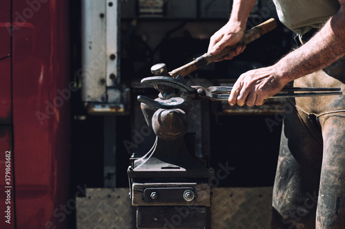 Blacksmith making a horseshoe photo