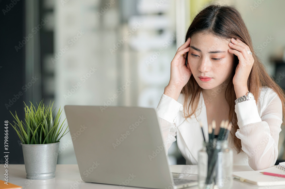 Portrait of female thinking about her work while sitting at worktable. Portrait of female thinking about her work while sitting at worktable.