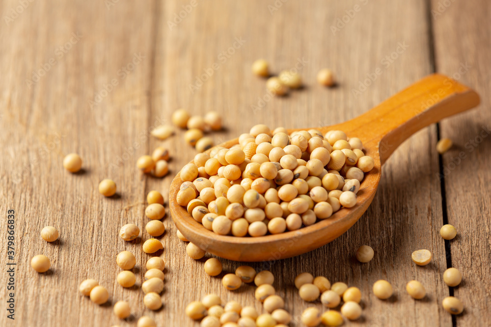 Soybean seeds on wooden floor and hemp sacks Food nutrition concept. Soybean seeds on wooden floor and hemp sacks Food nutrition concept.