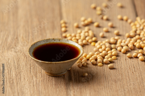 Soybean Sauce and Soybean on Wooden Floor Soy sauce Food nutrition concept.