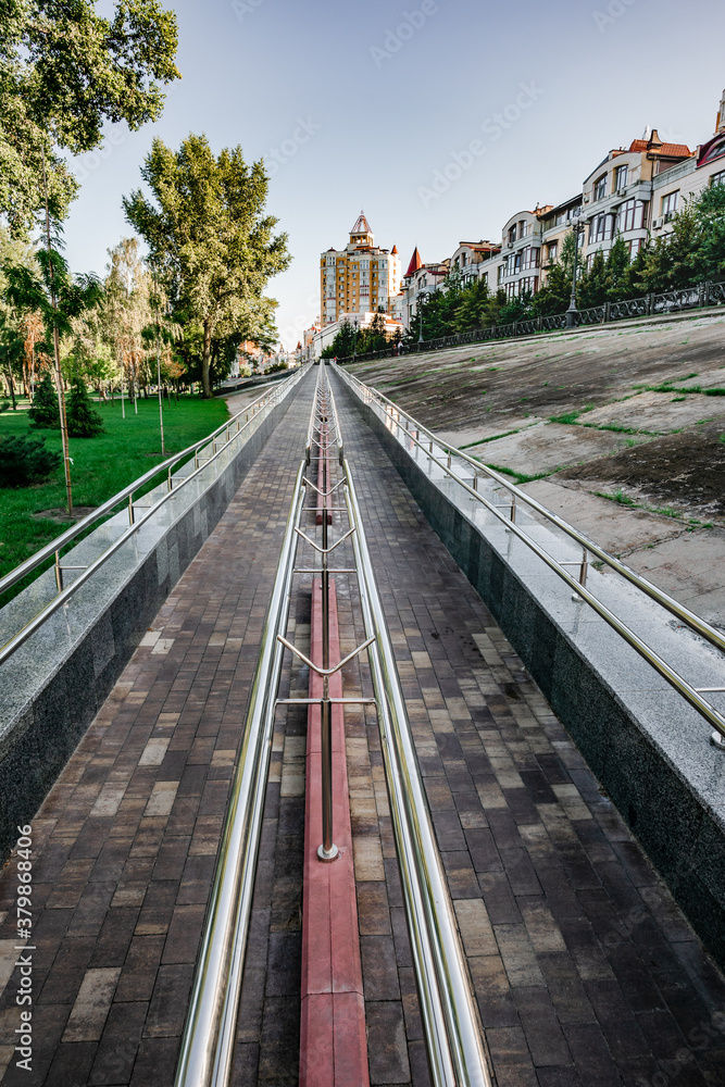 Obraz premium A long metal ramp for handicapped people, bicycles and people with strollers, near Natalka Park in the Obolon district of Kiev, Ukraine.