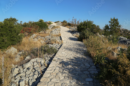 Walking path on the coast of the canal of St. Ante near Sibenik in Croatia