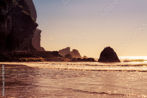 Retro style photo of a beautiful summer day at Piha Beach, New Zealand