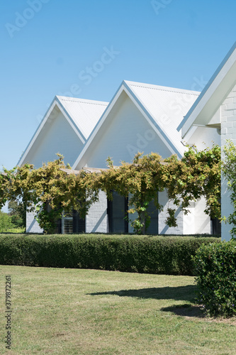 White Brick Country Homestead with tall pitched roofline photo