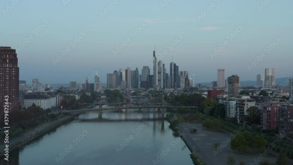 Empty Frankfurt am Main Skyline in early morning light reflecting in Skyscrapers with Main River and Bridges, Aerial sideways slide left Empty Frankfurt am Main Skyline in early morning light reflecting in Skyscrapers with Main River and Bridges, Aerial sideways slide left
