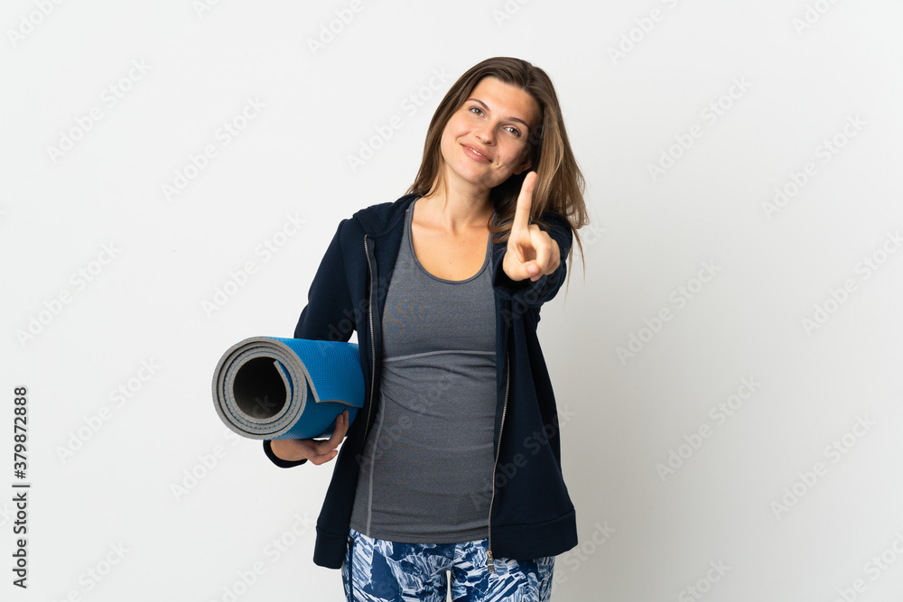 Slovak girl going to yoga classes isolated on white background showing and lifting a finger Slovak girl going to yoga classes isolated on white background showing and lifting a finger
