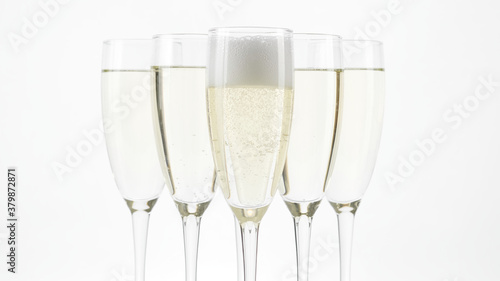Champagne. flute-style glasses with Sparkling Wine on Holiday Bokeh Blinking light background. Celebration