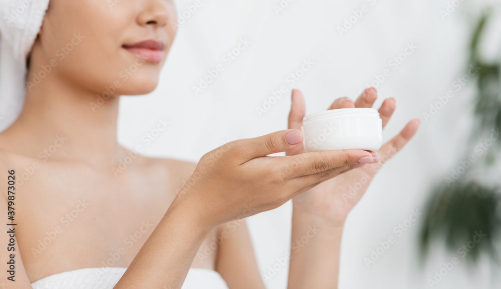 Jar with cream in young asian woman hands Jar with cream in young asian woman hands