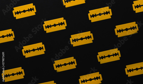 Yellow Razor blades for shaving on black background. photo