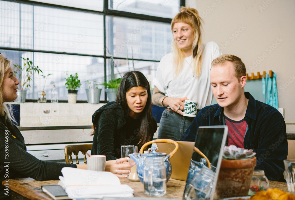 Four young entrepreneurs work on a business start up project