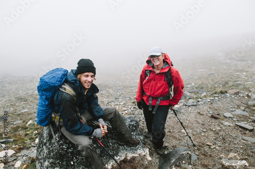 Male and female trekker, resting while climbing Chhukung Ri Peak, Everest Region, Nepal. photo