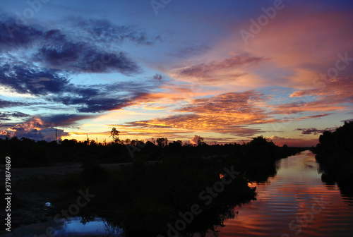 a golden hour of sunset in the riverbanks. sunset in the jungle © chandra