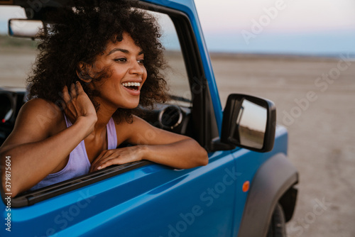 Photography Image of cheerful african american woman smiling while travelling in car