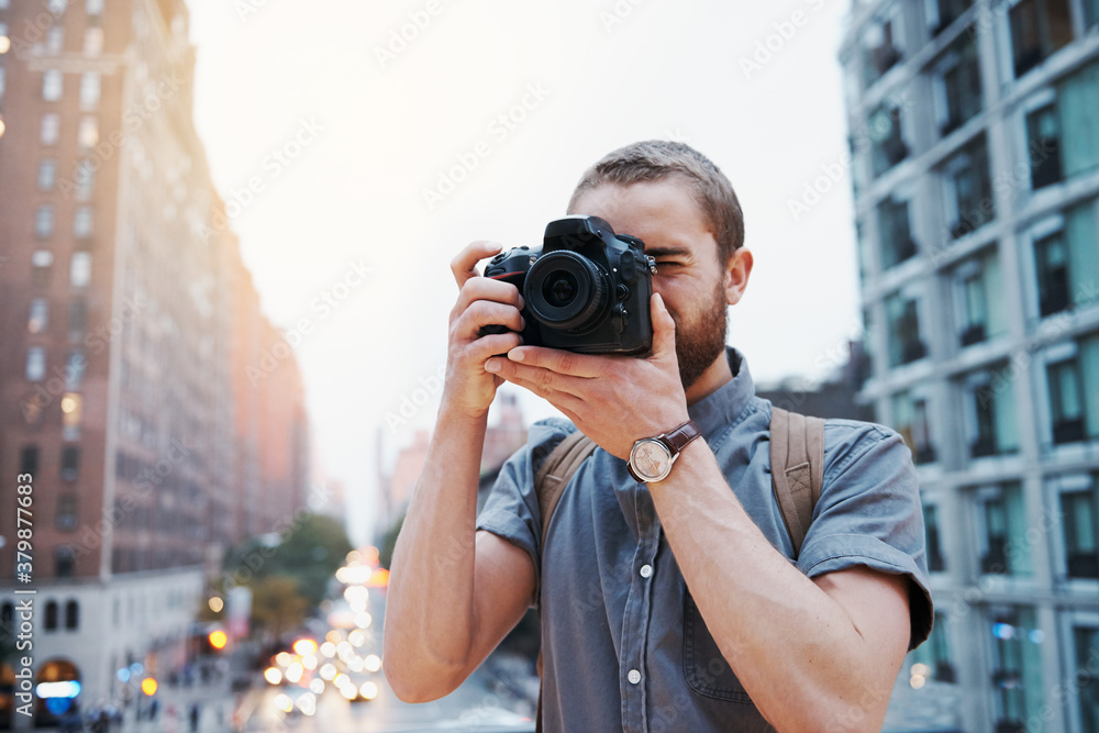 Young man taking photographs in the city Young man taking photographs in the city