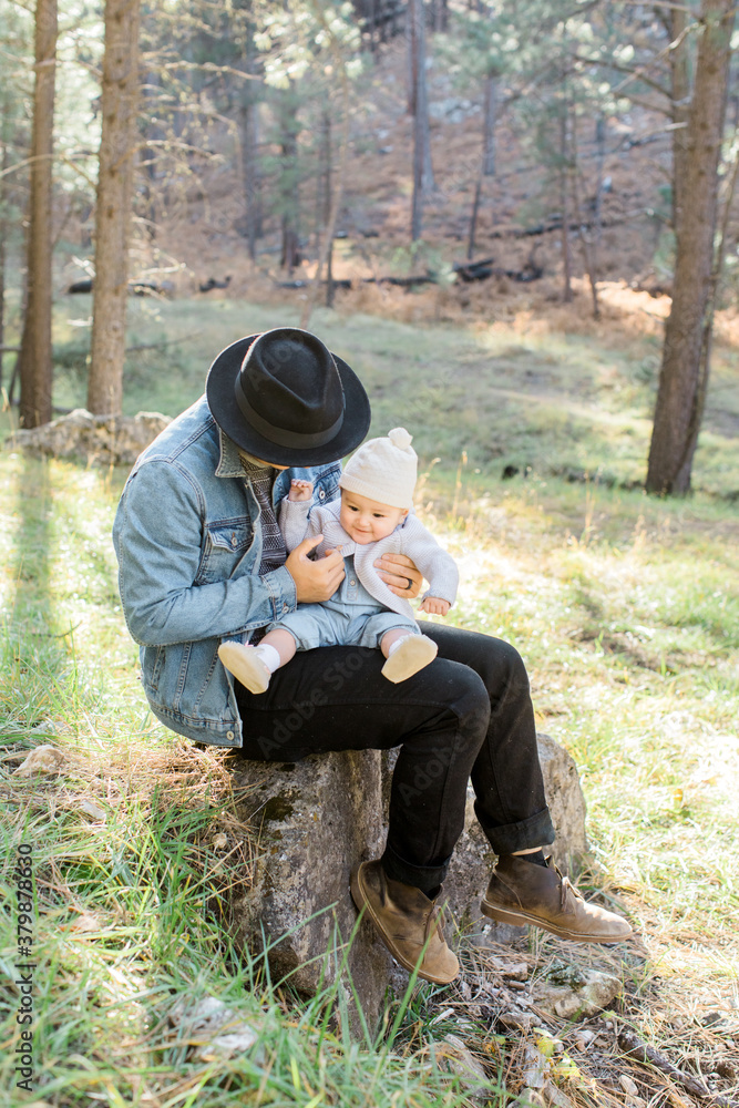Young dad holding baby outdoors Young dad holding baby outdoors