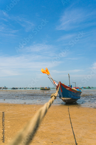 Colorful local fishing boats anchored by the coastline at Vung Tau, Vietnam. Selective focus