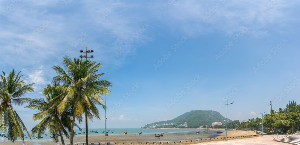 park in front beach of Vung Tau city with waves, coastline, streets, coconut trees and Tao Phung mountain in Vietnam