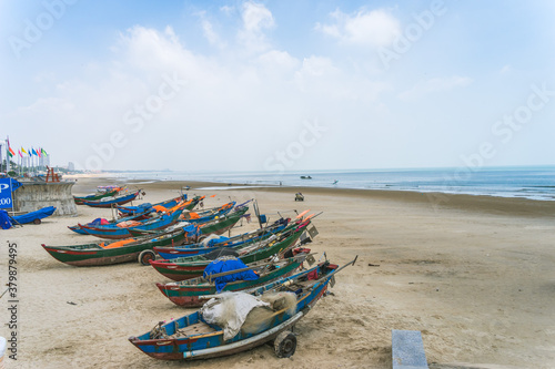 Colorful local fishing boats anchored by the coastline at Vung Tau, Vietnam. Selective focus photo