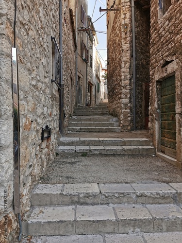 Tourist city by the Adratic sea - Sibenik, Croatia. The old stones, narrow street and stairs photo