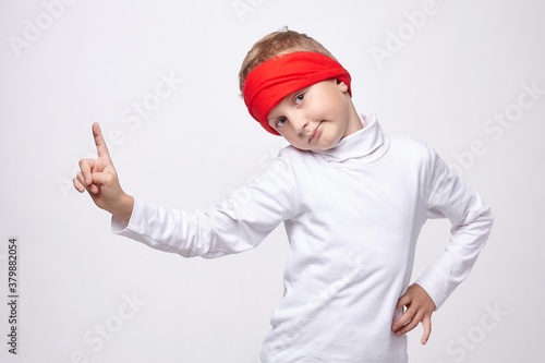 young man with a headband points up with his index finger. photo session in the Studio on a white background