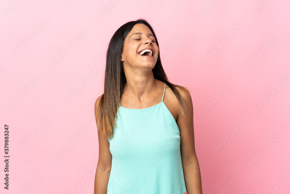 Caucasian girl isolated on pink background laughing Caucasian girl isolated on pink background laughing