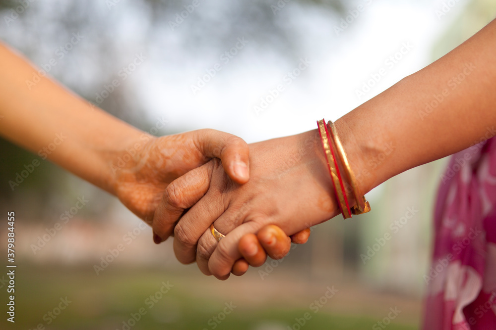 Mother holding hands to her daughter at outdoor Mother holding hands to her daughter at outdoor
