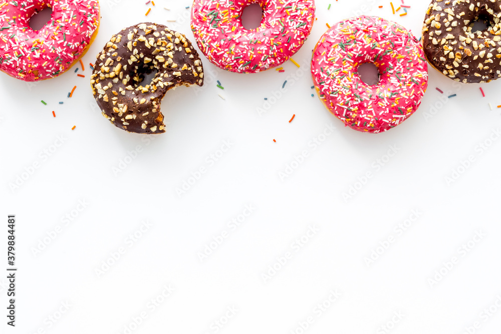 Donuts flat lay pattern on white background, top view Donuts flat lay pattern on white background, top view