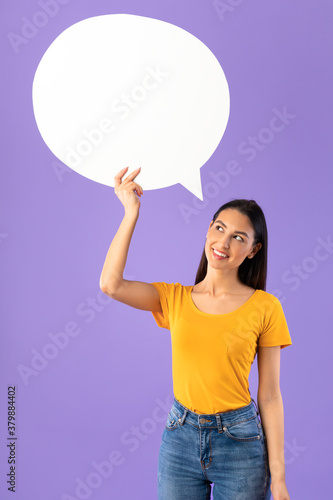 Portrait of thinking woman holding speech bubble © Prostock-studio