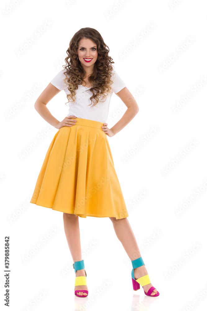 Confident Smiling Woman Is Posing In Yellow Skirt And Colorful High Heels.