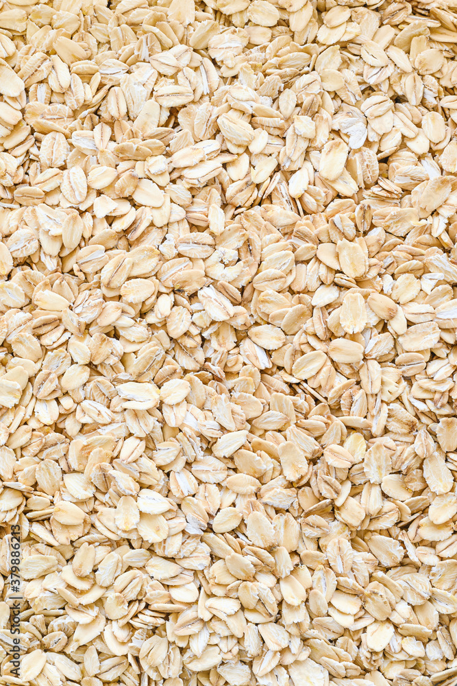 oatmeal close-up - vertical background. Ingredient for long-cooking porridge oatmeal close-up - vertical background. Ingredient for long-cooking porridge