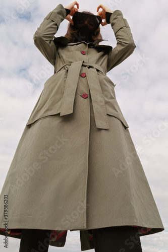 woman with green trench coat outdoors photo