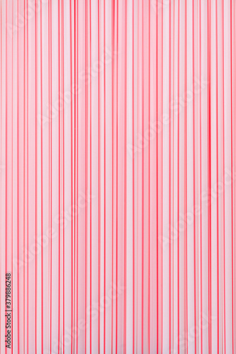 background of white and pink stripes plastic cocktail tubes