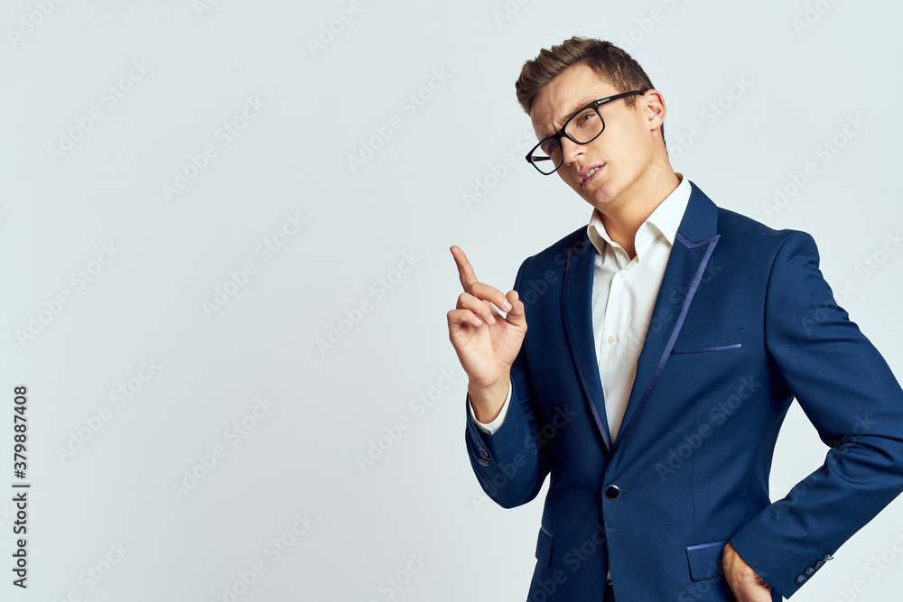 Business man wearing glasses blue suit cropped view official light background Business man wearing glasses blue suit cropped view official light background