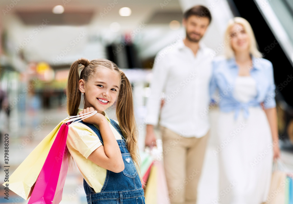 Daughter Holding Bags Walking With Parents Among Shops In Mall Daughter Holding Bags Walking With Parents Among Shops In Mall
