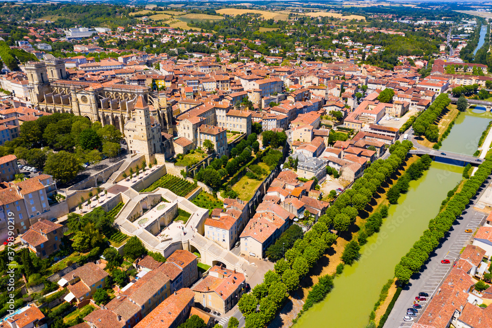 Aerial view of colorful Auch cityscape on Gers river with Sainte-Marie Cathedral and Tour d Armagnac on sunny summer day, France..