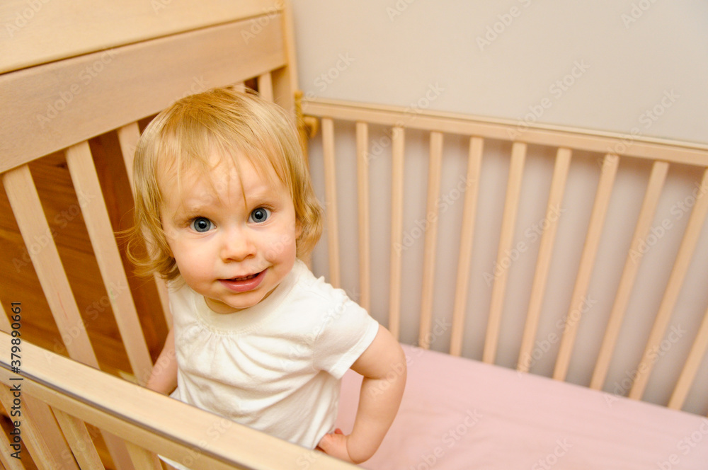 Happy Baby Girl Standing in Crib at Home Happy Baby Girl Standing in Crib at Home