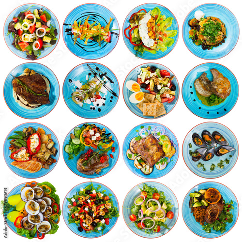 Collection of delicious restaurant and homemade dishes served on blue round plates isolated on white..