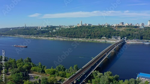 Wallpaper Mural Drone flying above the Dnepr river and Metro bridge pathing in direction to Pecherskaya Lavra and Motherland statue.  Beautiful  Kiev city in summer Ukraine 2020. Top view to highway with driving cars Torontodigital.ca