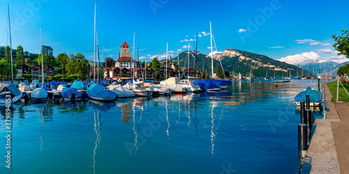 Spiez Church and Castle on the shore of Lake Thun with yachts in the Swiss canton of Bern, Spiez, Switzerland.