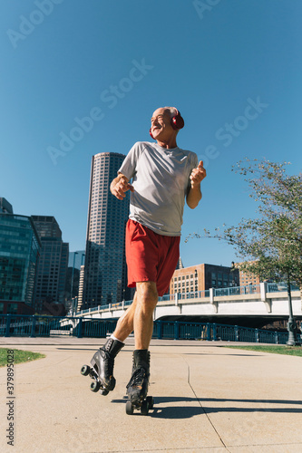 Active Senior Lifestyle Shot of Man Roller Skating in Urban Environment photo