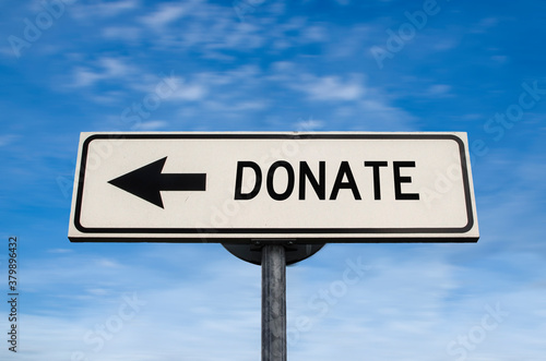 Donate sign. White street signs with arrow on metal pole with word. Directional road. Crossroads Road Sign, Arrow. Blue sky background. Charity.