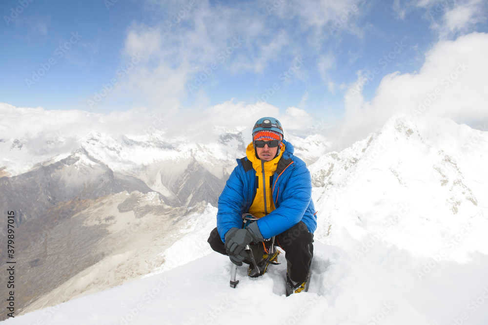 Alpinist on top of Alpamayo peak in Cordillera Blanca Alpinist on top of Alpamayo peak in Cordillera Blanca