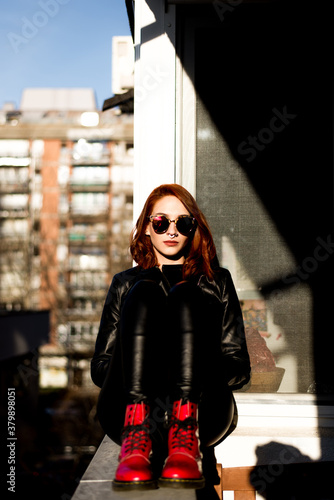 Portrait of beautiful ginger woman with red shoes